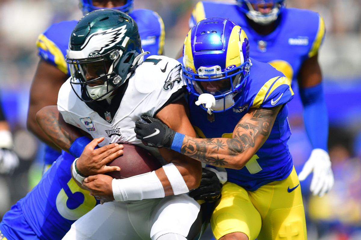 Philadelphia Eagles quarterback Jalen Hurts (1) runs the ball against Los Angeles Rams linebacker Ernest Jones (53) and cornerback Ahkello Witherspoon (44) during the first half at SoFi Stadium.